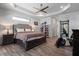 Cozy bedroom with a tray ceiling, neutral tones, and a sliding barn door at 13443 Boabadilla Ln, Port Charlotte, FL 33981