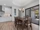 Dining area with a modern chandelier and sliding glass doors to the patio that allows for seamless indoor-outdoor entertaining at 13443 Boabadilla Ln, Port Charlotte, FL 33981