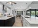 Modern kitchen featuring white cabinets, black island, and stainless steel appliances at 13443 Boabadilla Ln, Port Charlotte, FL 33981