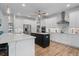 Bright kitchen with white cabinets, a dark island, and stainless steel appliances at 13443 Boabadilla Ln, Port Charlotte, FL 33981