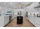 Modern kitchen with custom cabinets, stainless steel appliances, and island with black counter at 13443 Boabadilla Ln, Port Charlotte, FL 33981