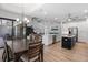Open-concept kitchen with white cabinets, black island, and adjacent dining area at 13443 Boabadilla Ln, Port Charlotte, FL 33981