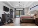 Comfortable main bedroom featuring a king-size bed, a large tv, and access to the pool area, perfect for relaxation and entertainment at 13443 Boabadilla Ln, Port Charlotte, FL 33981