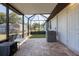 Covered patio with pavers and screening offers a comfortable outdoor living space at 13443 Boabadilla Ln, Port Charlotte, FL 33981