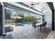 Inviting screened-in patio with a dining area and a pool, perfect for outdoor entertaining at 13443 Boabadilla Ln, Port Charlotte, FL 33981