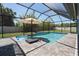 A screened-in pool with a seating area offers privacy and fun with an outdoor living space at 13443 Boabadilla Ln, Port Charlotte, FL 33981