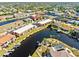 Aerial view showcases the waterfront condo community with a central pool and private docks at 1345 Mediterranean Dr # A105, Punta Gorda, FL 33950