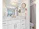 Bathroom with a sink, large mirror, and shower at 1345 Mediterranean Dr # A105, Punta Gorda, FL 33950