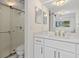 Bathroom features a glass-enclosed shower, toilet, and a modern white vanity with gold fixtures at 1345 Mediterranean Dr # A105, Punta Gorda, FL 33950