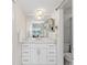 Bathroom with a sink and large mirror overlooking a waterfront at 1345 Mediterranean Dr # A105, Punta Gorda, FL 33950
