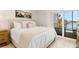 Tastefully designed bedroom with sliding doors to the lanai with serene water views at 1345 Mediterranean Dr # A105, Punta Gorda, FL 33950