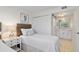 Comfortable bedroom featuring twin beds, coastal artwork, and a view of the bathroom at 1345 Mediterranean Dr # A105, Punta Gorda, FL 33950