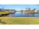 Beautiful waterfront canal with boat docks surrounded by palm trees and lush greenery at 1345 Mediterranean Dr # A105, Punta Gorda, FL 33950