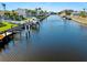 Scenic waterfront canal view with private boat docks, palm trees, and blue skies at 1345 Mediterranean Dr # A105, Punta Gorda, FL 33950