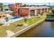 Condo exterior displaying landscaped grounds, canal access, and community swimming pool at 1345 Mediterranean Dr # A105, Punta Gorda, FL 33950