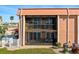 Two-story condo building with screened lanais and an in-ground pool area at 1345 Mediterranean Dr # A105, Punta Gorda, FL 33950