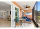Screened lanai featuring tile floors, fan, wicker furniture, and views from sliding doors at 1345 Mediterranean Dr # A105, Punta Gorda, FL 33950