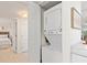 Convenient laundry area featuring a stacked washer and dryer, perfect for space-saving efficiency at 1345 Mediterranean Dr # A105, Punta Gorda, FL 33950