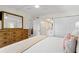 Bright bedroom with a large mirror and ceiling fan that provides access to other rooms in the home at 1345 Mediterranean Dr # A105, Punta Gorda, FL 33950
