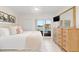 Cozy bedroom featuring a king bed, tile floors, a ceiling fan and a large sliding glass door at 1345 Mediterranean Dr # A105, Punta Gorda, FL 33950