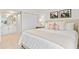 Comfortable main bedroom featuring neutral tones, closet, and access to a bathroom at 1345 Mediterranean Dr # A105, Punta Gorda, FL 33950