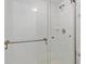 Modern bathroom shower with white tile, a glass door, and brushed silver fixtures at 1345 Mediterranean Dr # A105, Punta Gorda, FL 33950