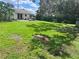 A spacious backyard featuring mature trees and ample space for recreation and relaxation at 1457 Sheehan Blvd, Port Charlotte, FL 33952