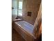 Bathroom features a tiled shower and a window that provides ample natural light at 1457 Sheehan Blvd, Port Charlotte, FL 33952
