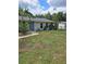 Lovely single-story home featuring a lush front yard and welcoming curb appeal at 1457 Sheehan Blvd, Port Charlotte, FL 33952