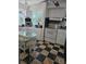 Kitchen with white cabinetry, checkered floors, and natural light coming from the windows at 1457 Sheehan Blvd, Port Charlotte, FL 33952