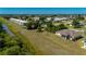 Expansive lot featuring lush landscaping and views of a nearby community with serene water views at 1606 Navigator Rd, Punta Gorda, FL 33983