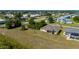 View of the back of a single Gathering home with screened in lanai at 1606 Navigator Rd, Punta Gorda, FL 33983