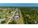 Aerial view of a single Gathering home along a golf course with ponds surrounded by lush trees at 1606 Navigator Rd, Punta Gorda, FL 33983