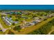Aerial view of a single Gathering home near a golf course with ponds, trees and grass areas at 1606 Navigator Rd, Punta Gorda, FL 33983