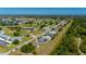 Aerial view of a single Gathering home along a golf course with lush trees, golf course and ponds at 1606 Navigator Rd, Punta Gorda, FL 33983