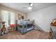 Stylish bedroom featuring a bunk bed with a slide, carpet, and modern ceiling fan at 1606 Navigator Rd, Punta Gorda, FL 33983