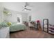 Cozy bedroom featuring a ceiling fan, carpeted floor, and a large window for plenty of natural light at 1606 Navigator Rd, Punta Gorda, FL 33983