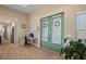 Bright foyer with double doors, a workspace, and views into the kitchen, under a tray ceiling at 1606 Navigator Rd, Punta Gorda, FL 33983