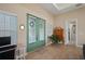 Inviting foyer area featuring double doors with wreaths, a side table, and neutral paint at 1606 Navigator Rd, Punta Gorda, FL 33983
