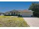 Well-maintained single-story home with inviting curb appeal, featuring a landscaped yard and attached two-car garage at 1606 Navigator Rd, Punta Gorda, FL 33983