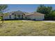 Inviting single-story home with manicured lawn and a two-car garage, under a clear blue sky at 1606 Navigator Rd, Punta Gorda, FL 33983