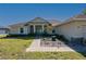 Close-up view of a single-story home's front exterior with a landscaped garden and charming entryway at 1606 Navigator Rd, Punta Gorda, FL 33983