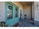 Charming front porch featuring double doors adorned with wreaths, plus cozy seating area under a covered entryway at 1606 Navigator Rd, Punta Gorda, FL 33983