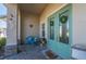 Welcoming front porch with double doors decorated with wreaths, paired with cozy seating, creating a charming entrance at 1606 Navigator Rd, Punta Gorda, FL 33983