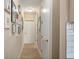 Hallway featuring light wood floors, recessed lighting, and a gallery wall of framed pictures at 1606 Navigator Rd, Punta Gorda, FL 33983