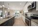 Charming eat-in kitchen featuring granite counters, stainless steel appliances, and light, wood-look tile flooring at 1606 Navigator Rd, Punta Gorda, FL 33983