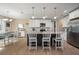 Bright kitchen featuring white cabinets, granite countertops, a central island with seating, and stainless steel appliances at 1606 Navigator Rd, Punta Gorda, FL 33983