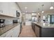 Beautiful kitchen featuring white cabinets, granite countertops, stainless steel appliances, and an island with a sink at 1606 Navigator Rd, Punta Gorda, FL 33983