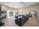 Spacious living room featuring a large sectional sofa, tile flooring, and access to the patio at 1606 Navigator Rd, Punta Gorda, FL 33983