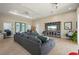 Open-concept living room with a large sectional sofa and home office setup, offering a versatile living space at 1606 Navigator Rd, Punta Gorda, FL 33983